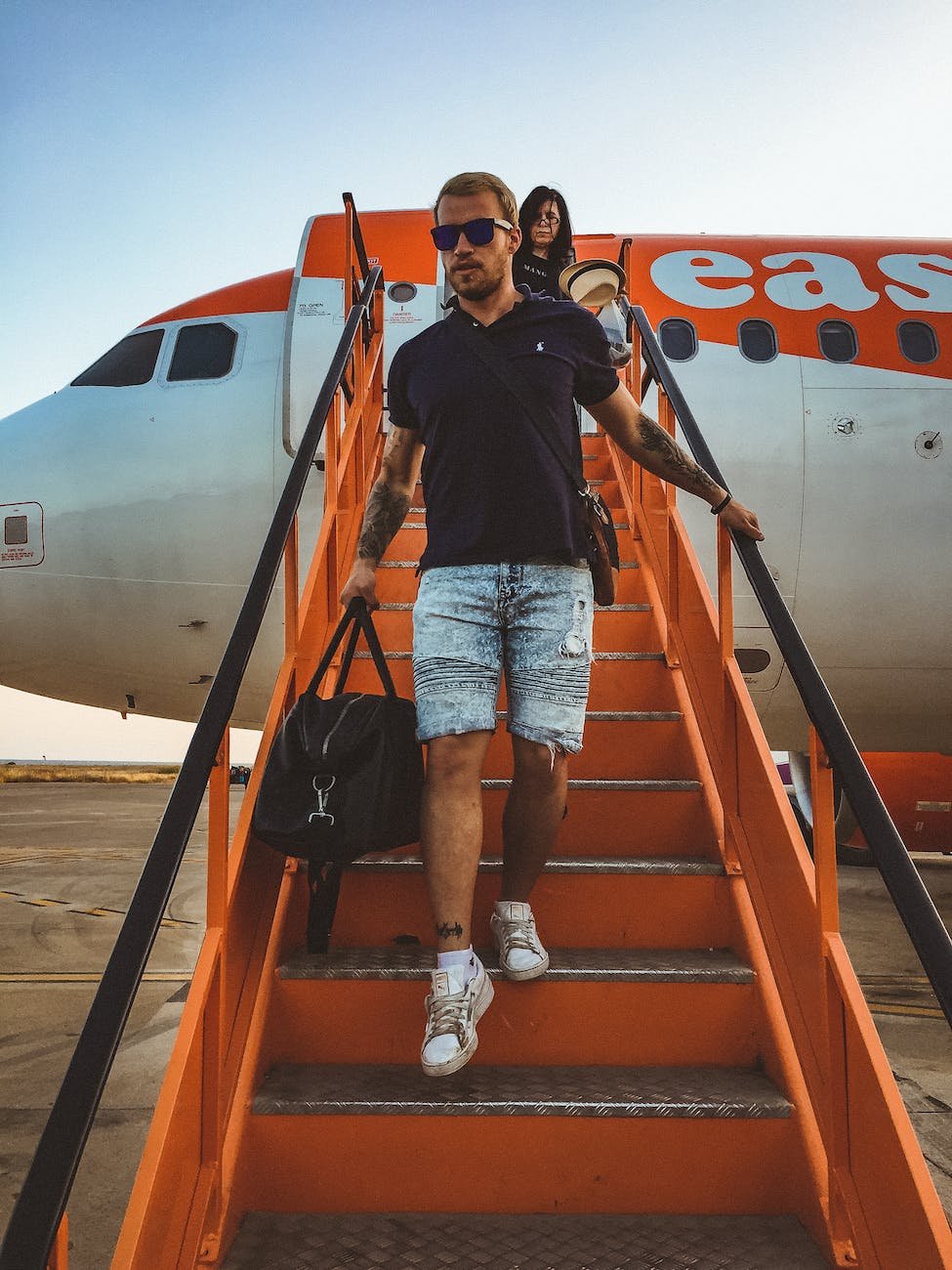 photo of man walking down the stairs