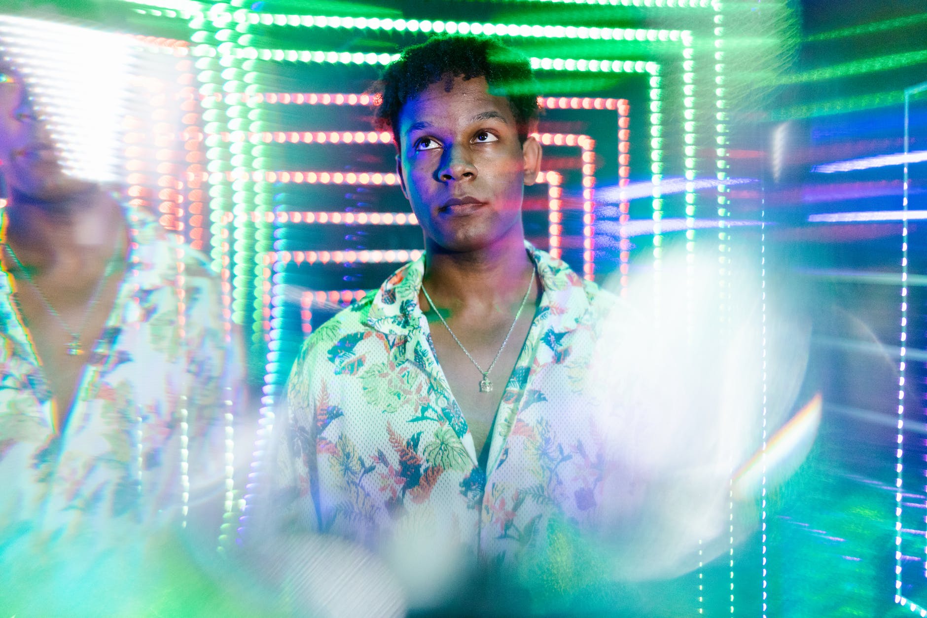 man in white green and blue floral button up shirt