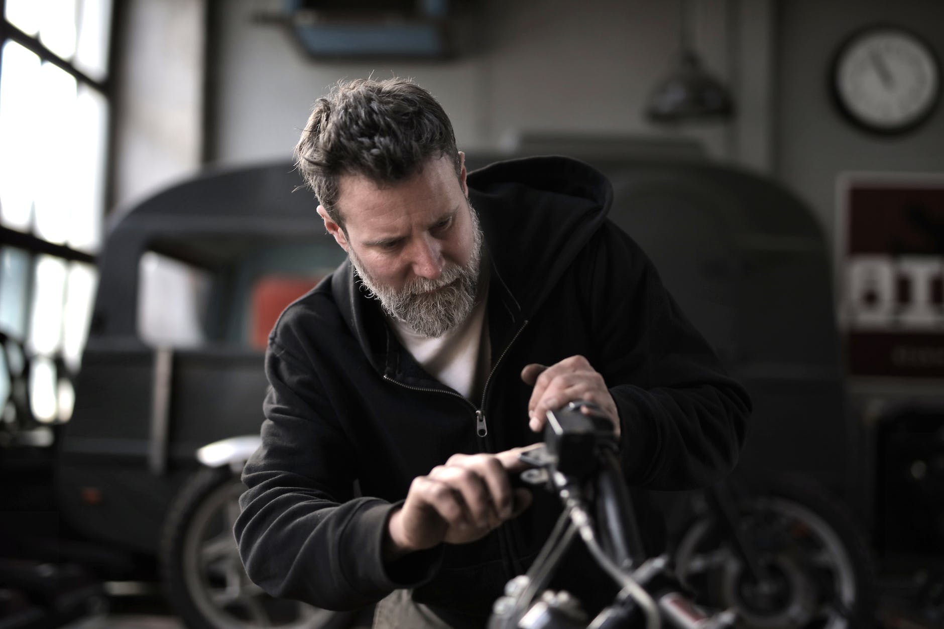 brutal man repairing motorbike in workshop
