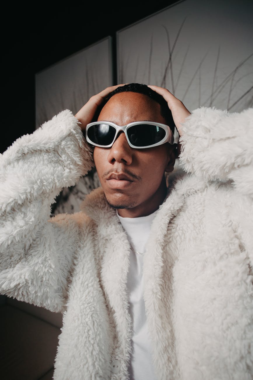 young man wearing a furry jacket and sunglasses