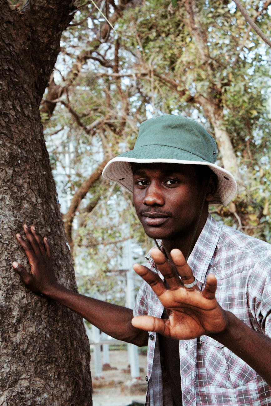 stylish black man in panama hat in park