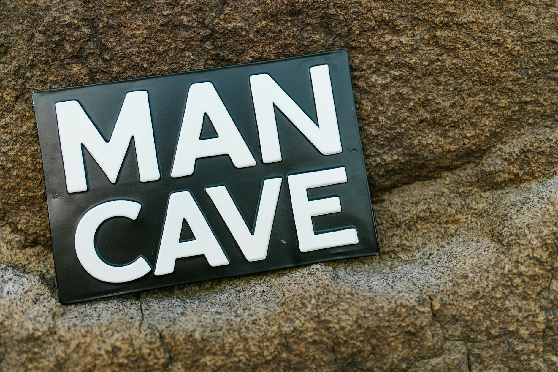 man cave sign on rock