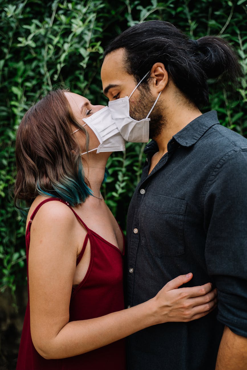 couple wearing face masks kissing