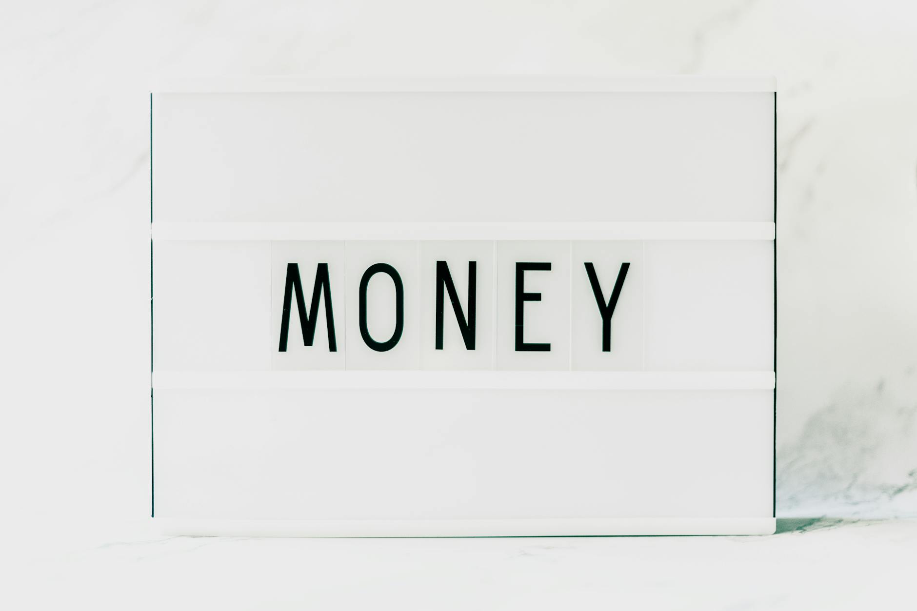 close up of a light box with a word money in the middle